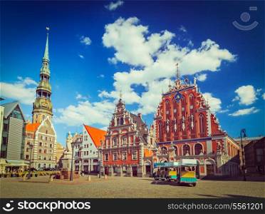 Vintage retro hipster style travel image of Riga Town Hall Square, House of the Blackheads and St. Peter&rsquo;s Church, Riga, Latvia