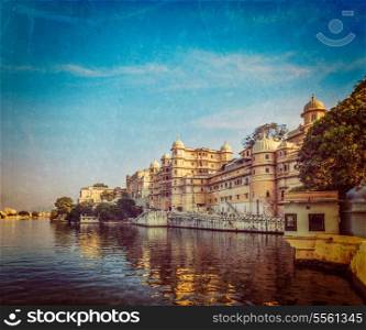 Vintage retro hipster style travel image of romantic India luxury tourism concept background - Udaipur City Palace and Lake Pichola. Udaipur, Rajasthan, India with grunge texture overlaid