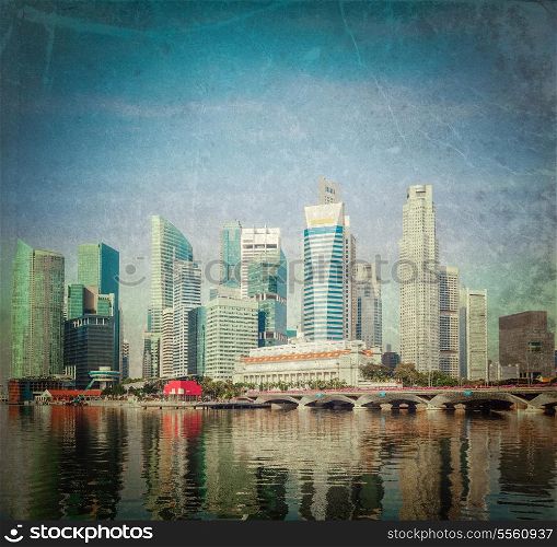 Vintage retro hipster style travel image of Singapore business district skyscrapers and Marina Bay in day