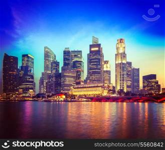 Vintage retro hipster style travel image of Singapore skyline and river in evening