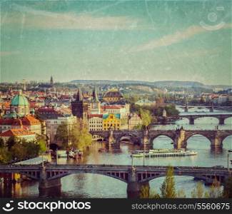 Vintage retro hipster style travel image of travel Prague concept background - elevated view of bridges over Vltava river from Letna Park with grunge texture overlaid. Prague, Czech Republic