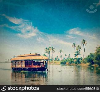 Vintage retro hipster style travel image of travel tourism Kerala background - houseboat on Kerala backwaters with grunge texture overlaid. Kerala, India