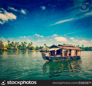 Vintage retro hipster style travel image of travel tourism Kerala background - houseboat on Kerala backwaters with grunge texture overlaid. Kerala, India