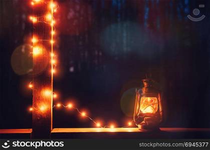 Vintage retro lantern with bokeh lights over dark background