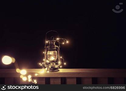 Vintage retro lantern with lights over dark background