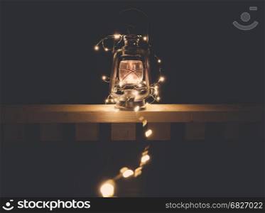 Vintage retro lantern with lights over dark background