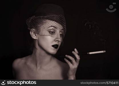 vintage Retro portrait of beautiful young caucasian woman in veil with cigarette closeup