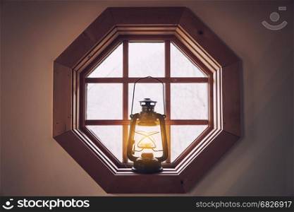 Vintage retro style metal lantern on the window