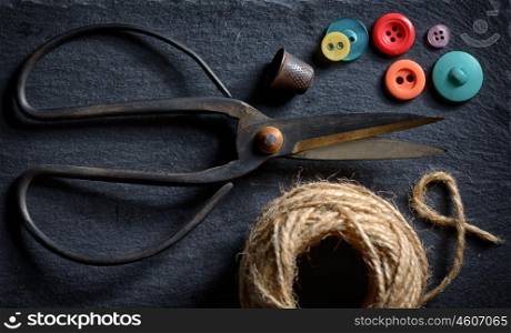 vintage scissors with a roll of twine and buttons