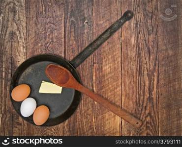 vintage set for frying eggs over wooden table, space for your text
