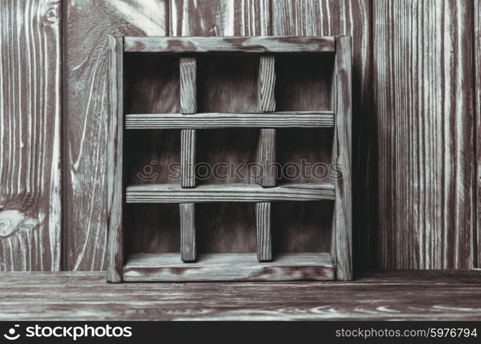 Vintage shelf stand on the wooden background. The vintage shelf