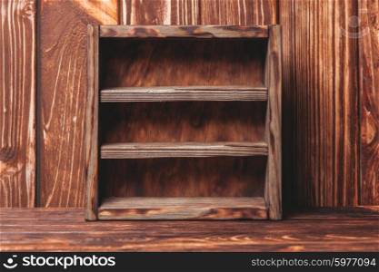 Vintage shelf stand on the wooden background. Vintage shelf