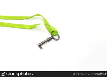 Vintage silver key with green ribbon isolated on white background