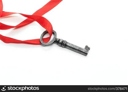 Vintage silver key with red ribbon isolated on white background