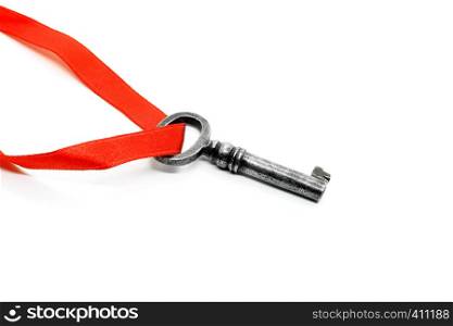 Vintage silver key with red ribbon isolated on white background