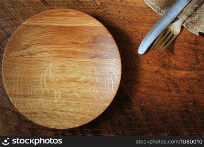 Vintage silverware, plate, napkin on rustic wooden background. Top view of kitchen setting table .. Vintage silverware, plate, napkin on rustic wooden background. Top view of kitchen setting table