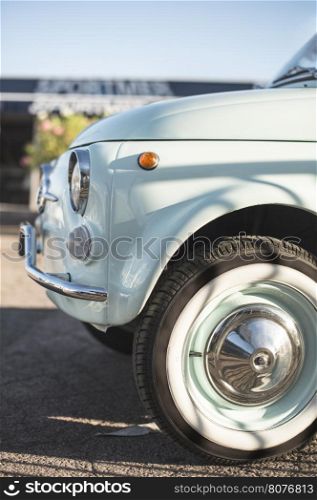 Vintage small blue car on sunlight