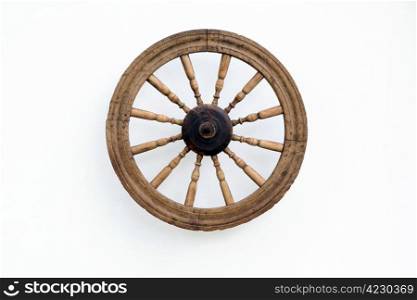 Vintage spinning wheel against the shabby white wall background