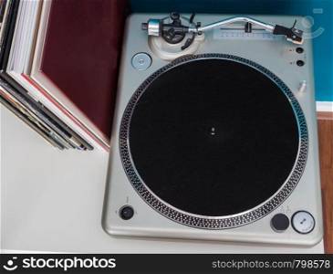Vintage stereo turntable vinyl record player with old lps on a shelve ariel view. Vintage stereo turntable vinyl record player with old lps on a shelve