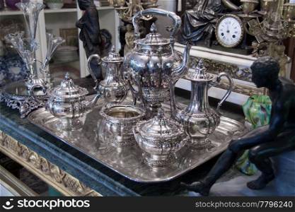 Vintage sterling silver Coffee Tea set displayed in antique store