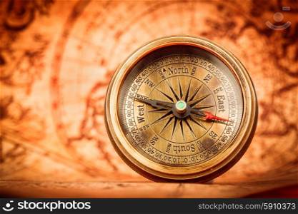 Vintage still life. Vintage compass lies on an ancient world map in 1565.