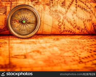 Vintage still life. Vintage compass lies on an ancient world map in 1565.