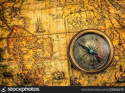 Vintage still life. Vintage compass lies on an ancient world map of 1565.