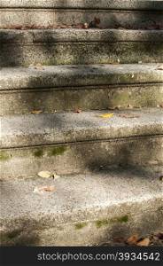 Vintage stone steps in front of old town house closeup with light shadows