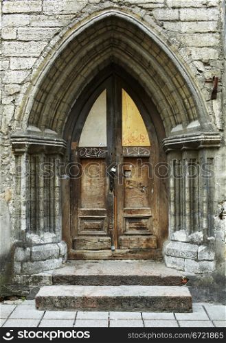 Vintage style arch and door with stained-glass window in Tallinn, Estonia