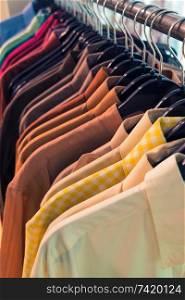 Vintage style image of male mens shirts on hangers in a shop display or wardrobe closet rail