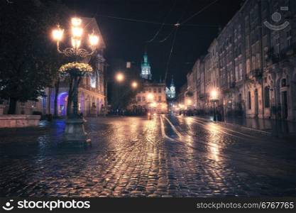 Vintage style image of old European city at night