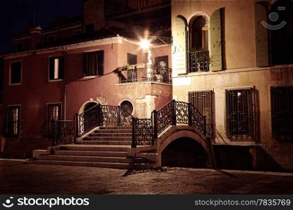 Vintage style image of Venice street at night, Venice, Italy