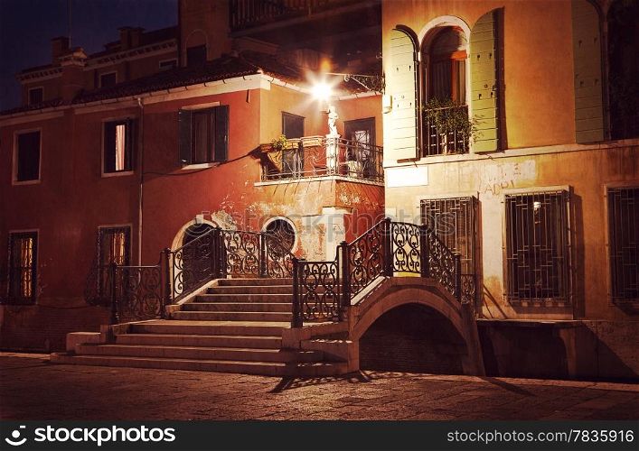 Vintage style image of Venice street at night, Venice, Italy