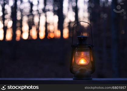 Vintage style lamp with a candle at night