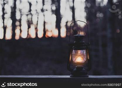 Vintage style lamp with a candle at night