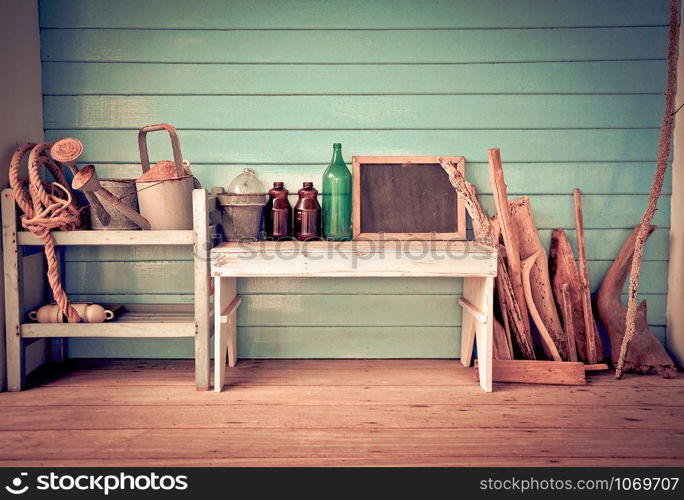 Vintage Style object and tools for agriculture garden with watering can rope on shelves wooden and blackboard bottle glass jar on table old wooden background