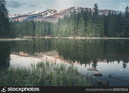 Vintage style photo of misty mountain lake