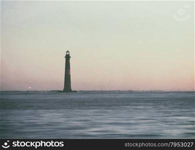 Vintage style photo of Morris Island Lighthouse at sunrise, South Carolina, USA