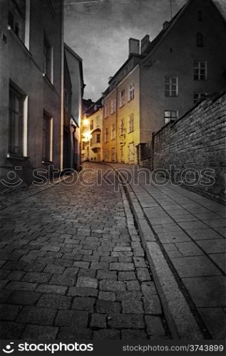 Vintage style photo of old European town street at night