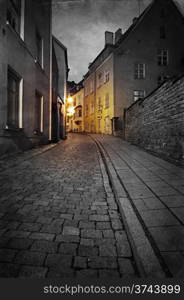 Vintage style photo of old European town street at night