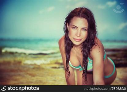 Vintage style portrait of beautiful brunet woman posing on the beach, beach fashion, summer vacation on tropical resort