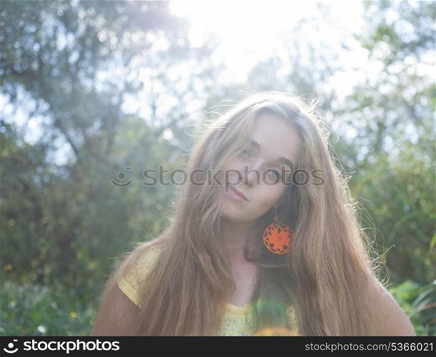 Vintage stylized image of the happy long haired blonde woman outdoors