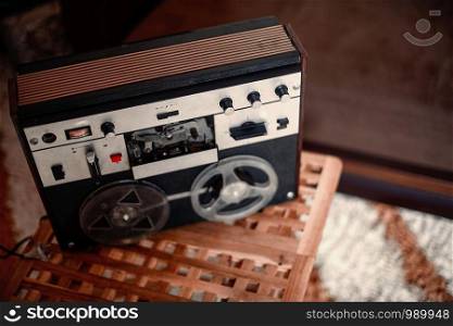 vintage tape recorder with coils of magnetic tape. soft selective focus with small depth of field