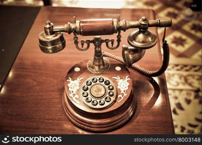 Vintage telephone on old table
