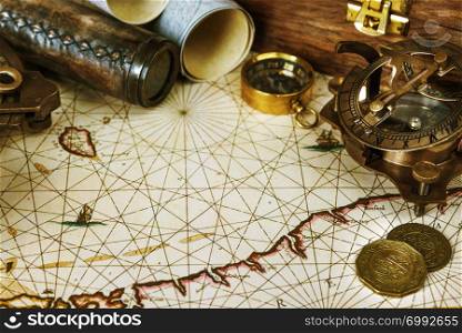 Vintage toned men&rsquo;s still life with compass, sextant, spyglass and old maps