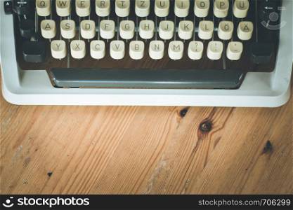 Vintage typewriter on a wooden desk, cutout