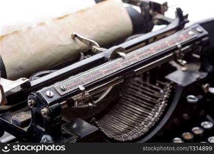 Vintage typewriter ribbon mechanism with inserted old paper closeup.. Vintage typewriter ribbon mechanism closeup