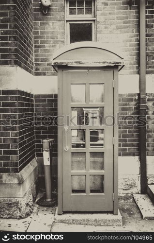 Vintage UK red phone booth, black and white picture. Vintage UK red phone booth