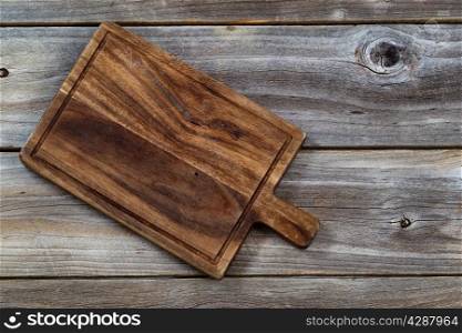Vintage walnut wood serving board for food on aged wooden boards