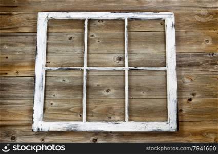 Vintage window, fading white paint, on rustic cedar wooden boards.